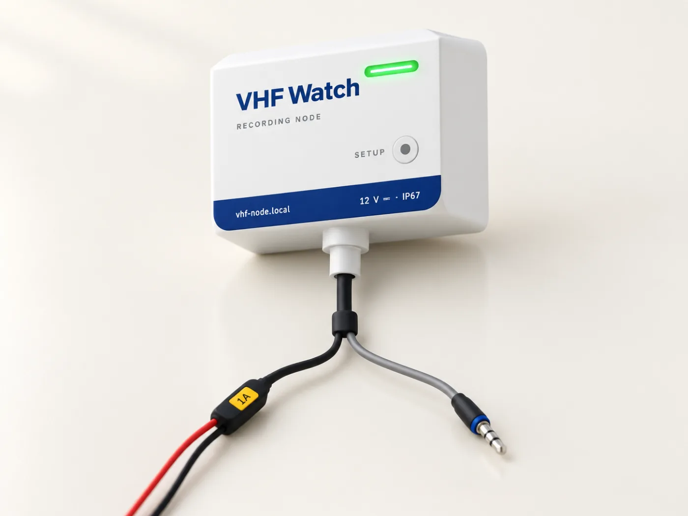 The VHF Watch recorder: a small white box with a navy band, a green light bar and a setup key. One cable leaves the bottom and splits into a red and black power lead with a 1 A fuse and an audio lead with a 3.5 mm plug.